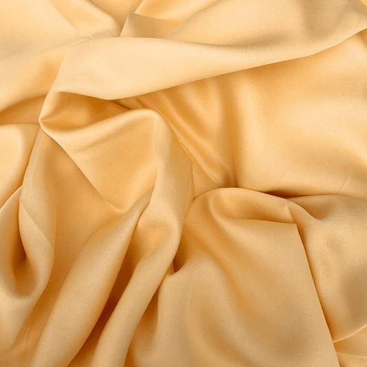 Soft and silky bamboo cotton fabric in light beige tone with natural wrinkles