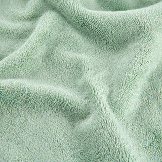 Green bamboo towel set showing soft textured fabric surface detail in close-up view