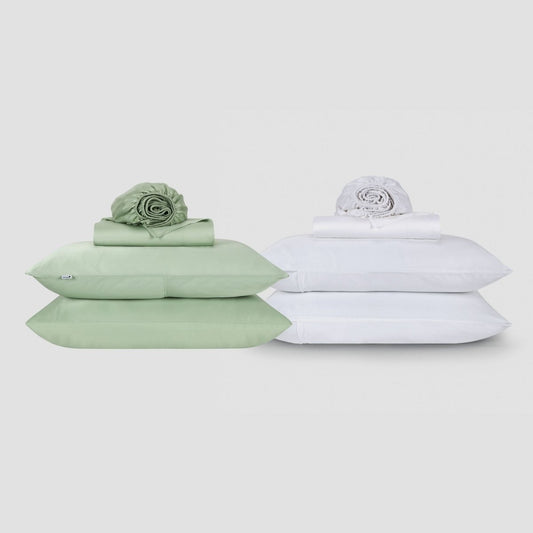 Two Momo Cotton sheet sets displayed side by side, one in sage green and one in white, each stacked with folded linens