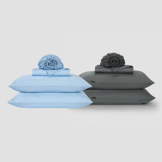 Two Momo Cotton sheet sets displayed side by side in light blue and charcoal gray with rolled duvet covers