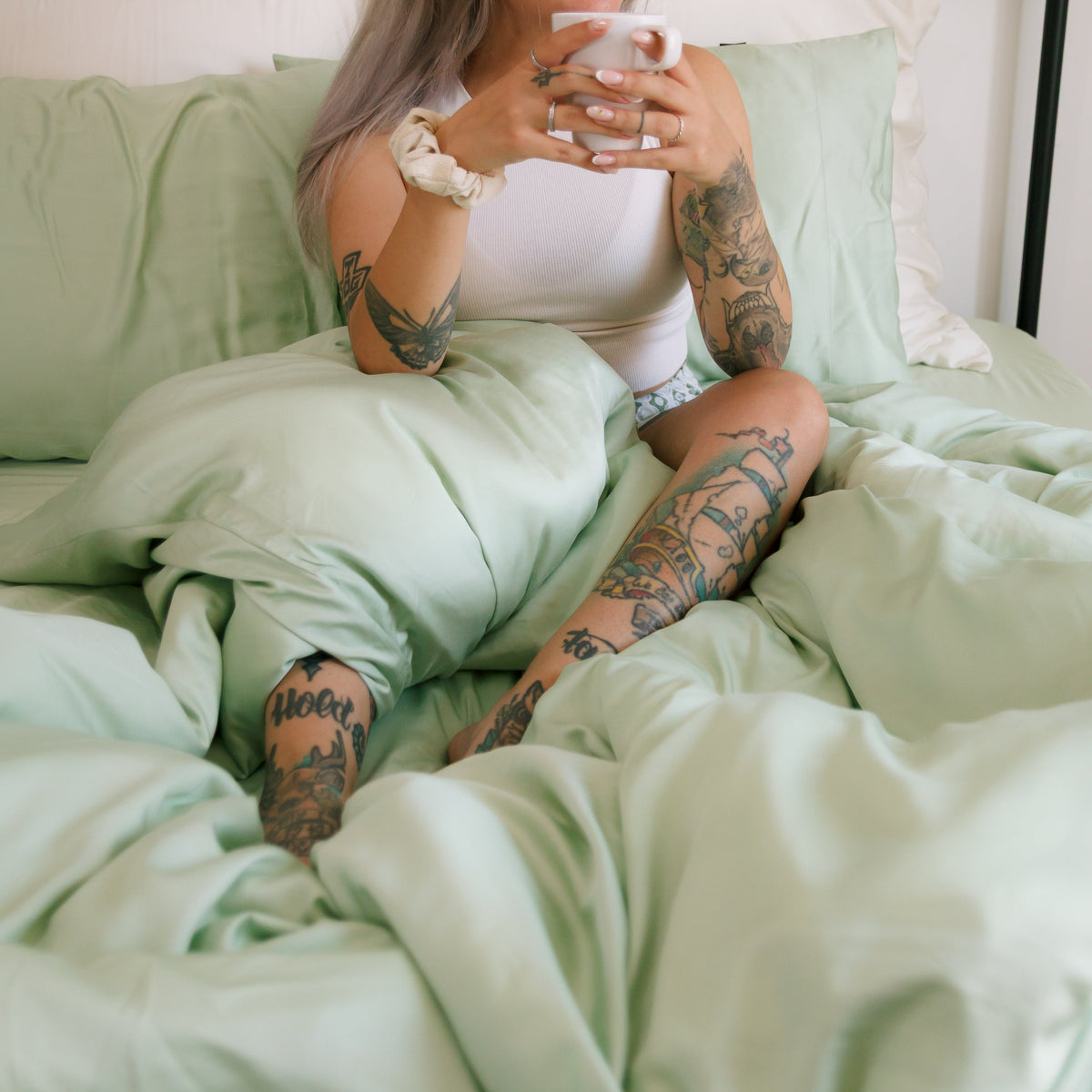 Mint green duvet cover set displayed on bed with white bedding, showcasing fabric softness and comfort