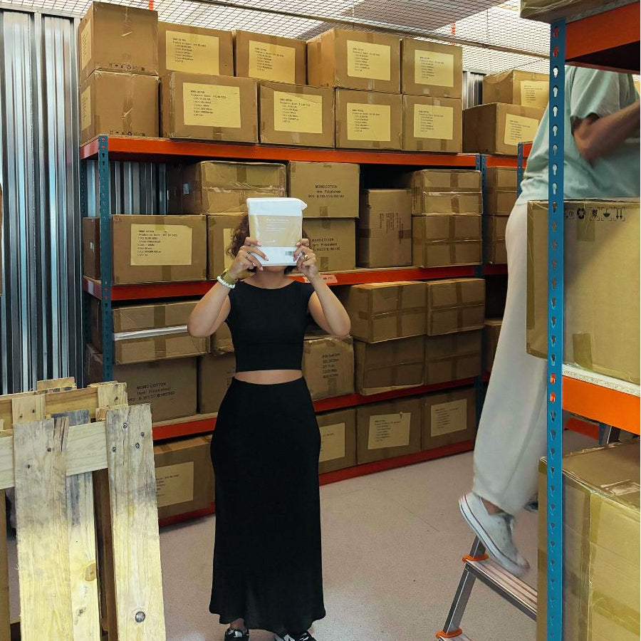 Employee in the warehouse olding bedlinen pack