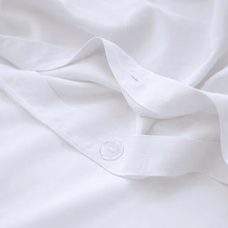 White bamboo cotton bedding set with visible button detail on folded sheet